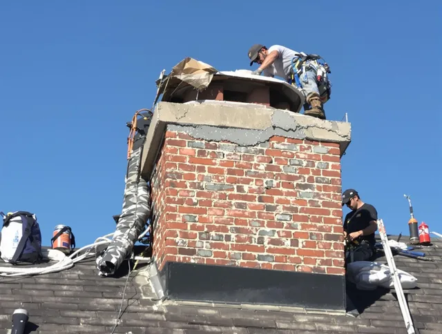 Rialto Chimney Sweep installing a custom chimney crown in Rialto, CA